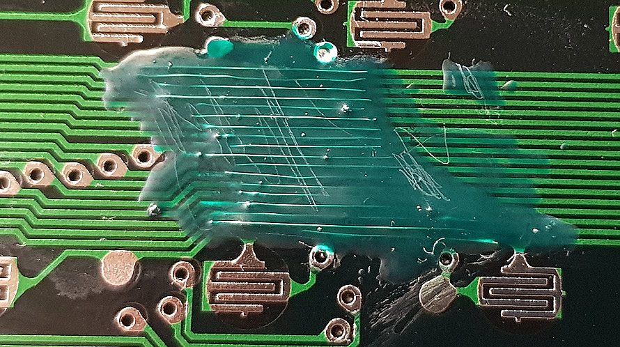 UV cure resin covering repaired PCB